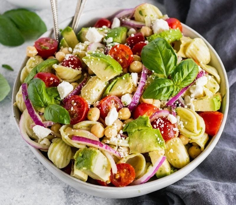 mediterranean pasta salad in a bowl with two spoons