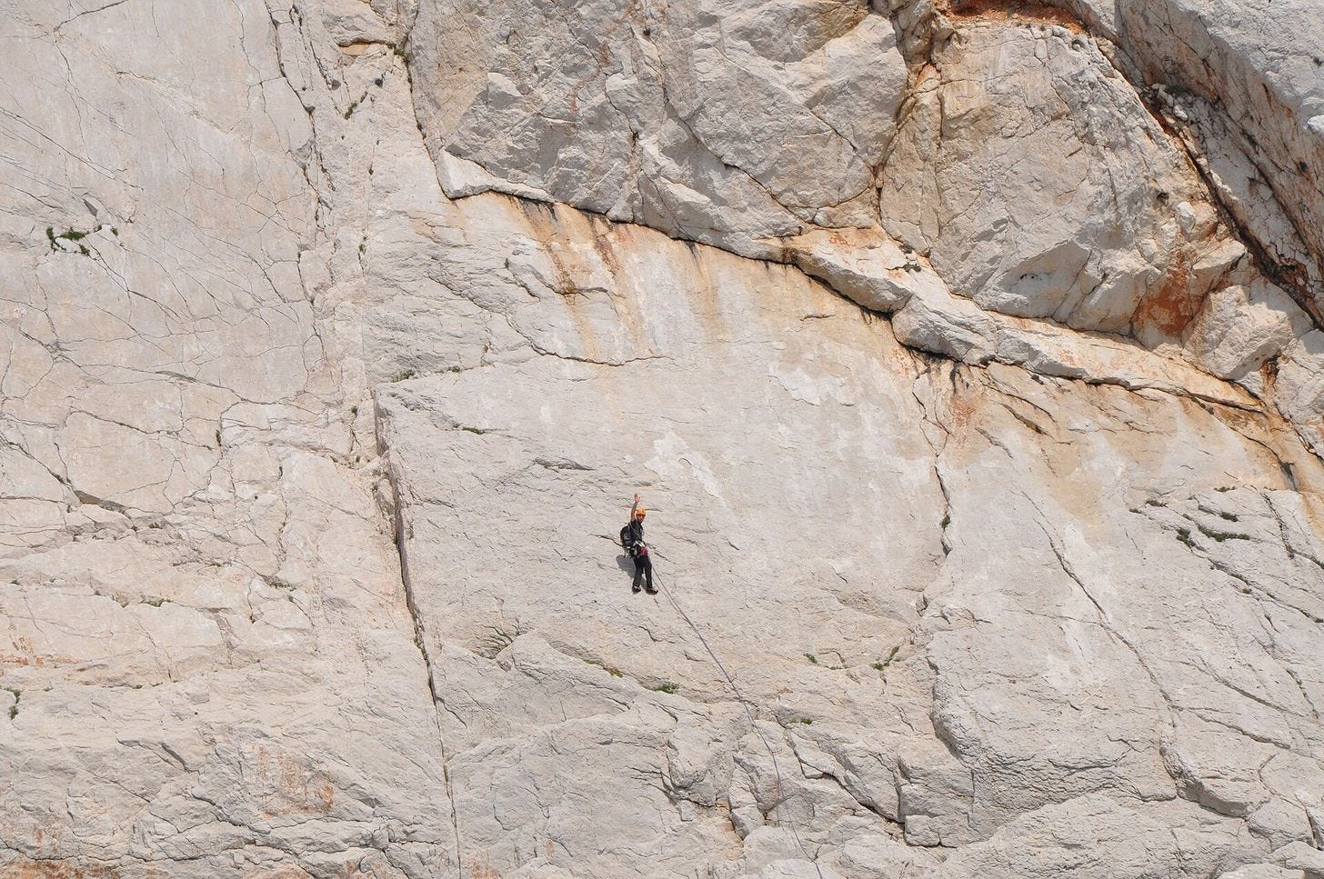 A lone climber on a white limestone wall in the Calanques A lone climber on a white limestone wall in the Calanques
