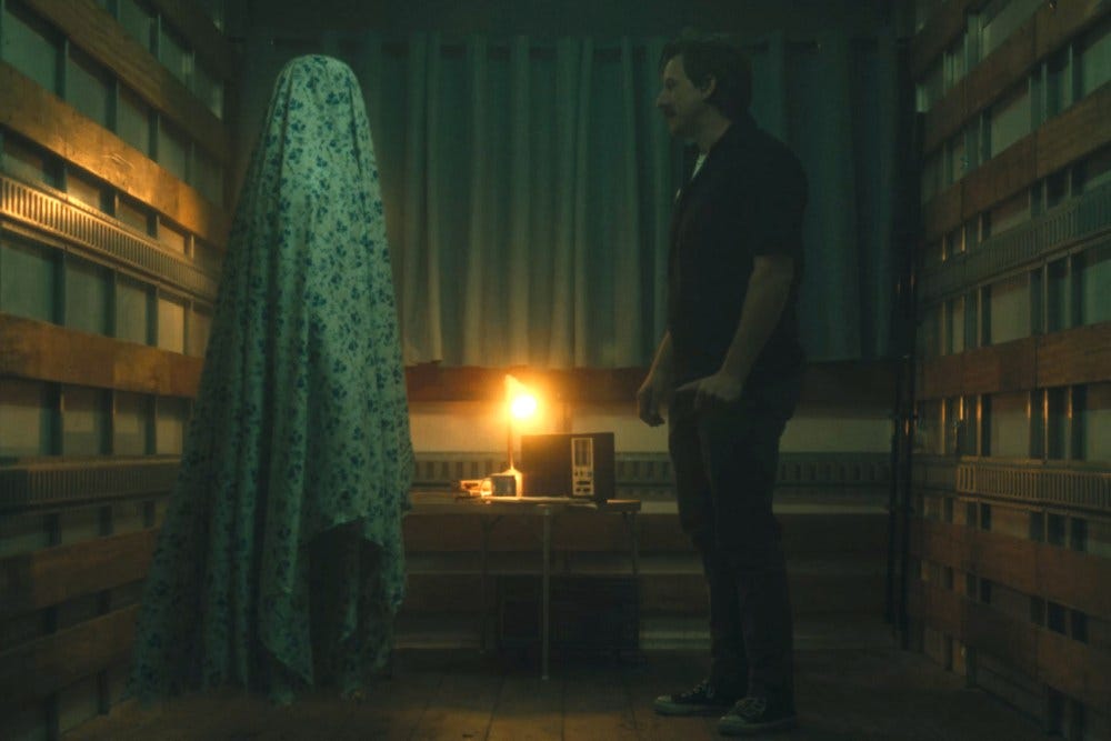Ghost in a sheet opposite man