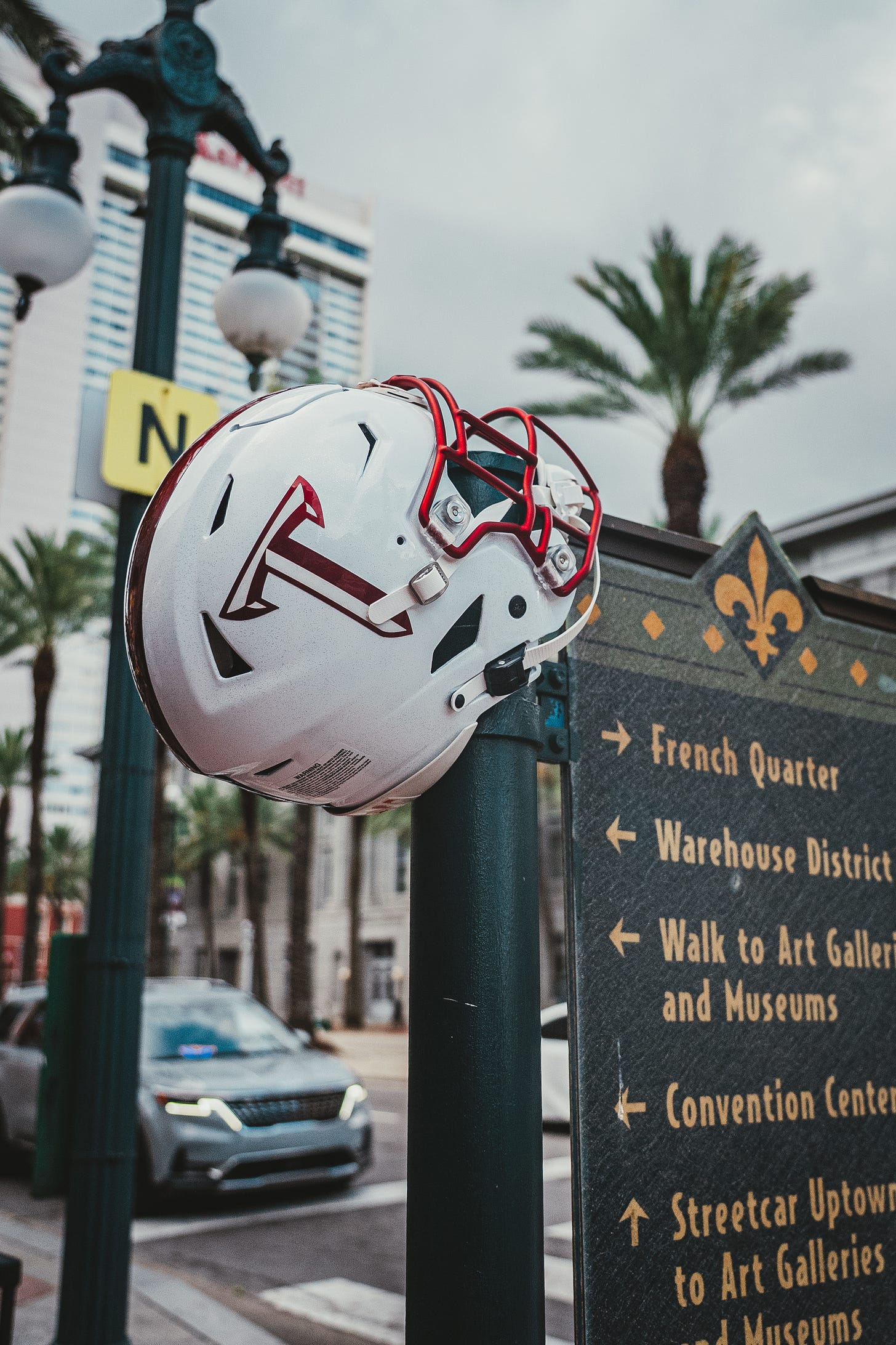 A Troy football helmet sits on a street sign in New Orleans for the Sun Belt conference Media Day.