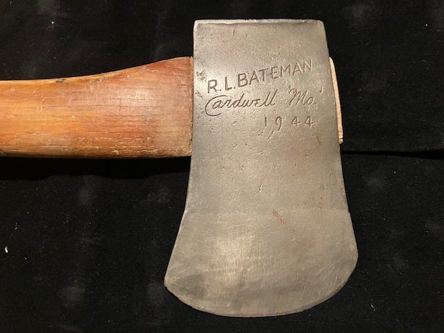 An axe with a wooden handle

AI-generated content may be incorrect.