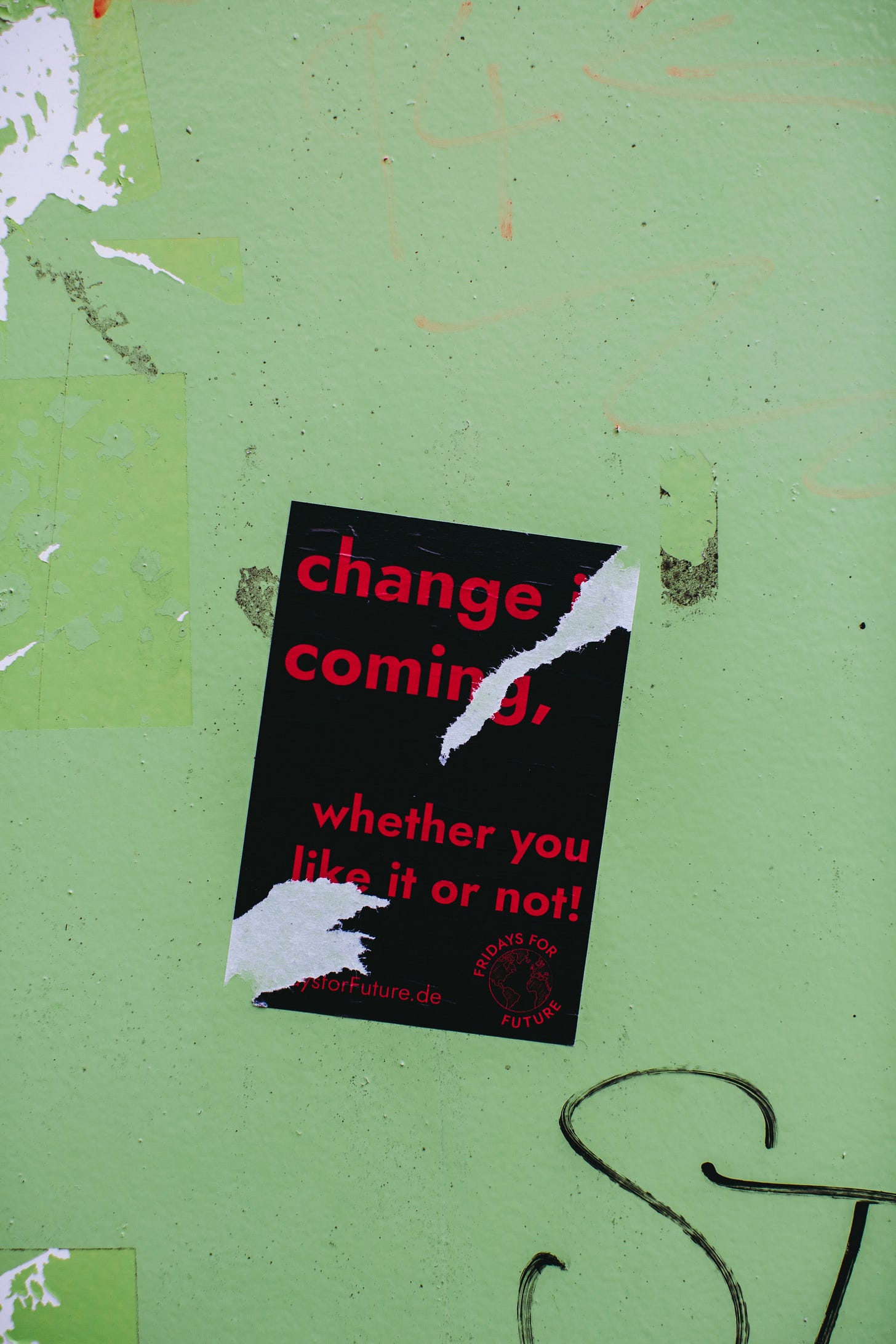 A ripped poster that says "change is coming whether you like it or not" A ripped poster that says "change is coming whether you like it or not"