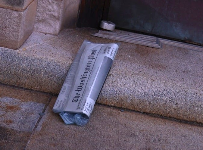 A metal object laying on the ground next to a door
