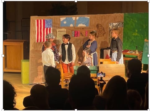 students on stage at MCS during a recent play