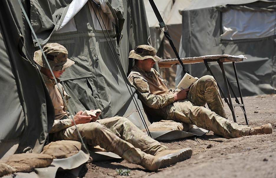 The image shows two soldiers in camouflage uniforms, sitting at a makeshift table, using military equipment, and resting under a large, tent-like structure.
AI-generated content may be incorrect. The image shows two soldiers in camouflage uniforms, sitting at a makeshift table, using military equipment, and resting under a large, tent-like structure.
AI-generated content may be incorrect.