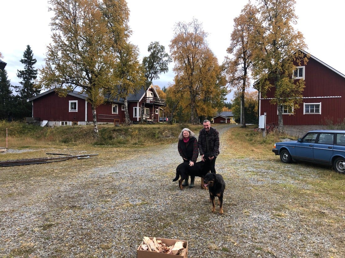 A middle aged couple with two Rottweiler dogs on the yard of a Swedish farm A middle aged couple with two Rottweiler dogs on the yard of a Swedish farm