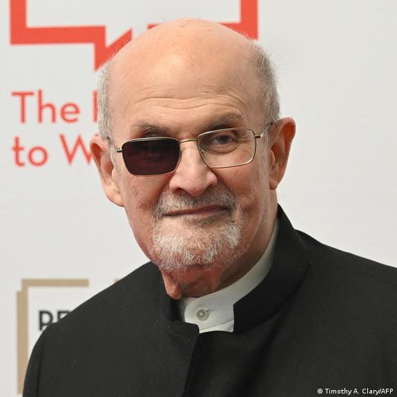 Salman Rushdie wearing glasses with one side shaded.