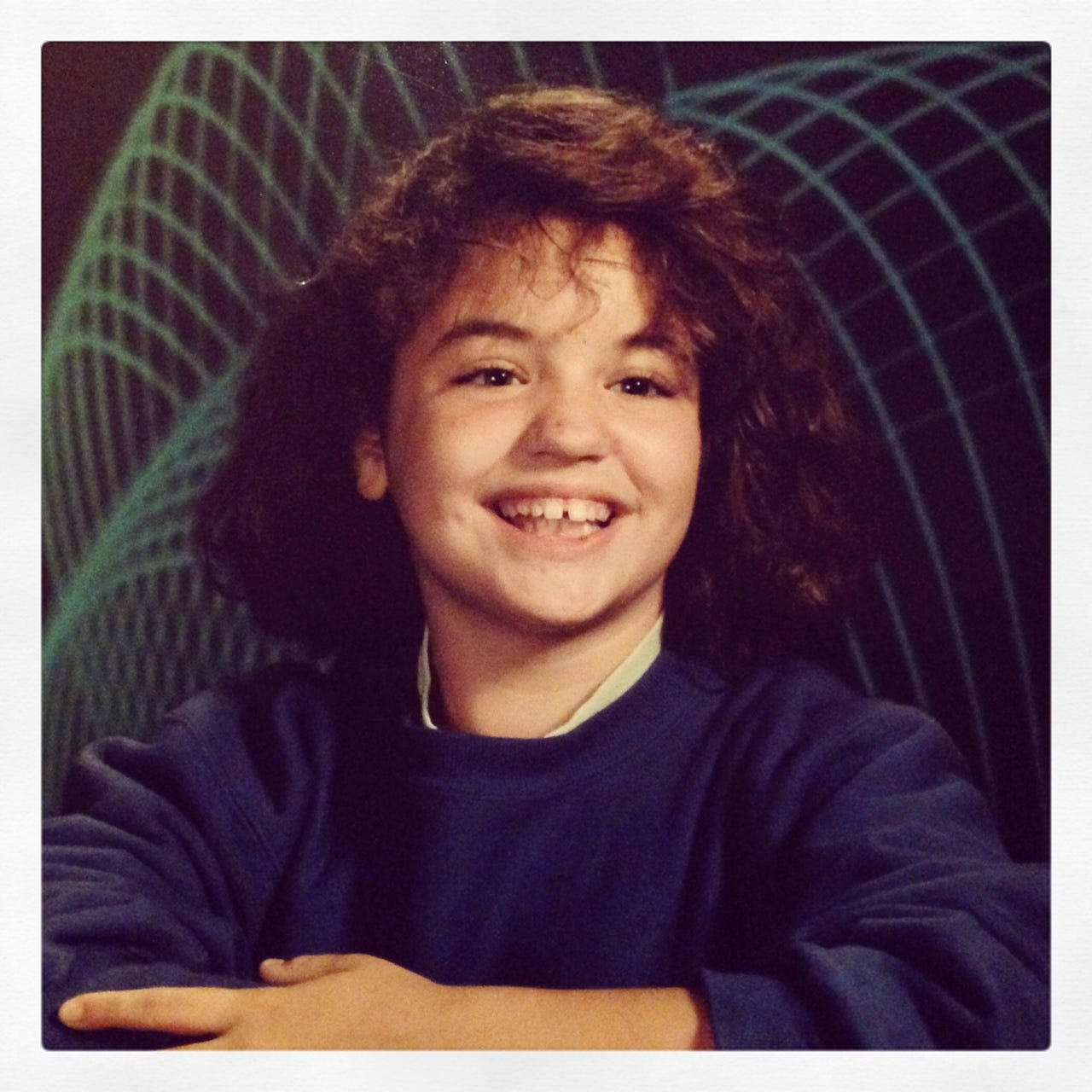 A school photo of me in 7th or 8th grade with laser beams in the background. I have frizzy hair, gap teeth, a huge overbite, and a zit on my nose. A school photo of me in 7th or 8th grade with laser beams in the background. I have frizzy hair, gap teeth, a huge overbite, and a zit on my nose.