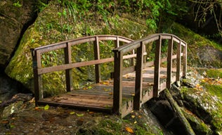 A small wooden bridge. A small wooden bridge.