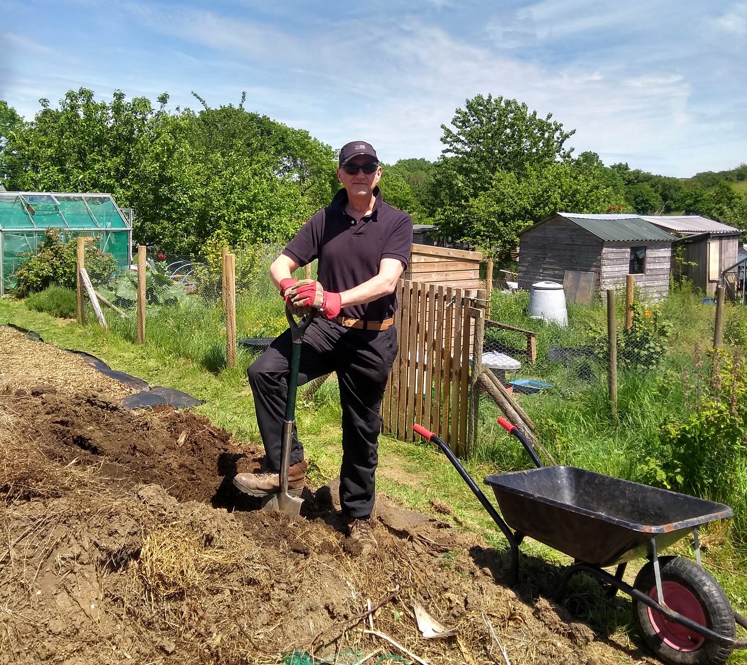the author digging a vegetable plot while wearing a baseball cap and sunglasses the author digging a vegetable plot while wearing a baseball cap and sunglasses