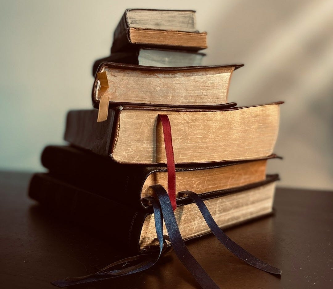 a stack of books sitting on top of a table