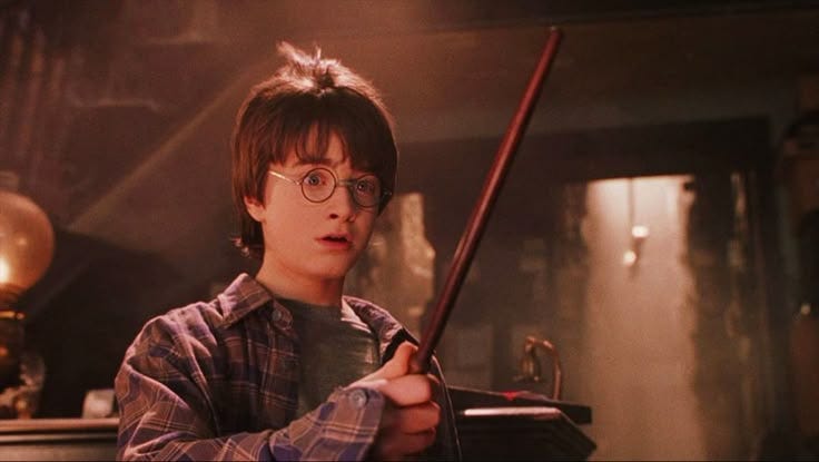 This may contain: a young harry potter holding a wand in his hand