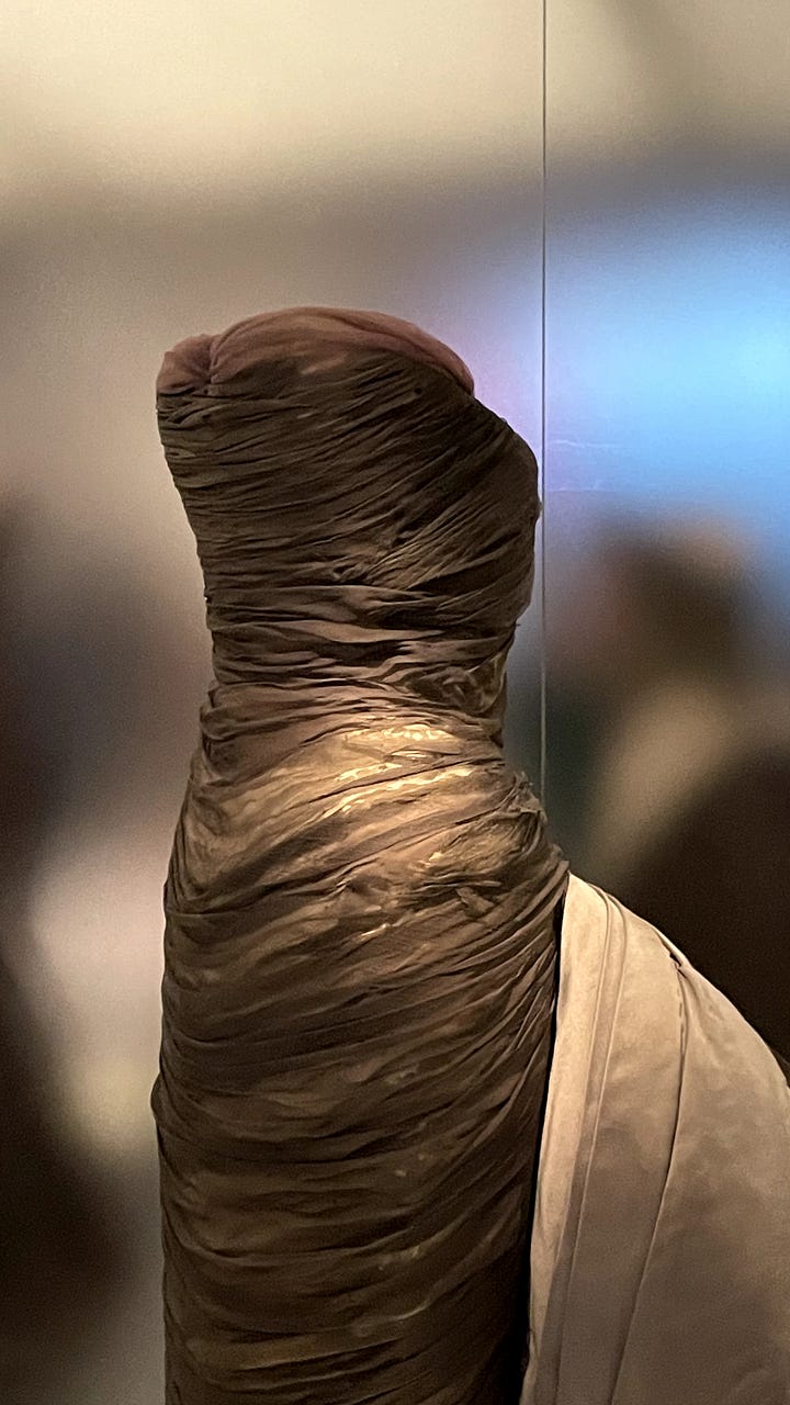 LEFT: The shoulder of a silk charmeuse dress pleated in Fortuny's signature wavy style with fine cord weaving in and out of the edges to connect the front and back body. RIGHT: The upper bodice of a gown covered in horizontally pleated chiffon over a lighter base with a sweetheart neckline and strapless silhouette.