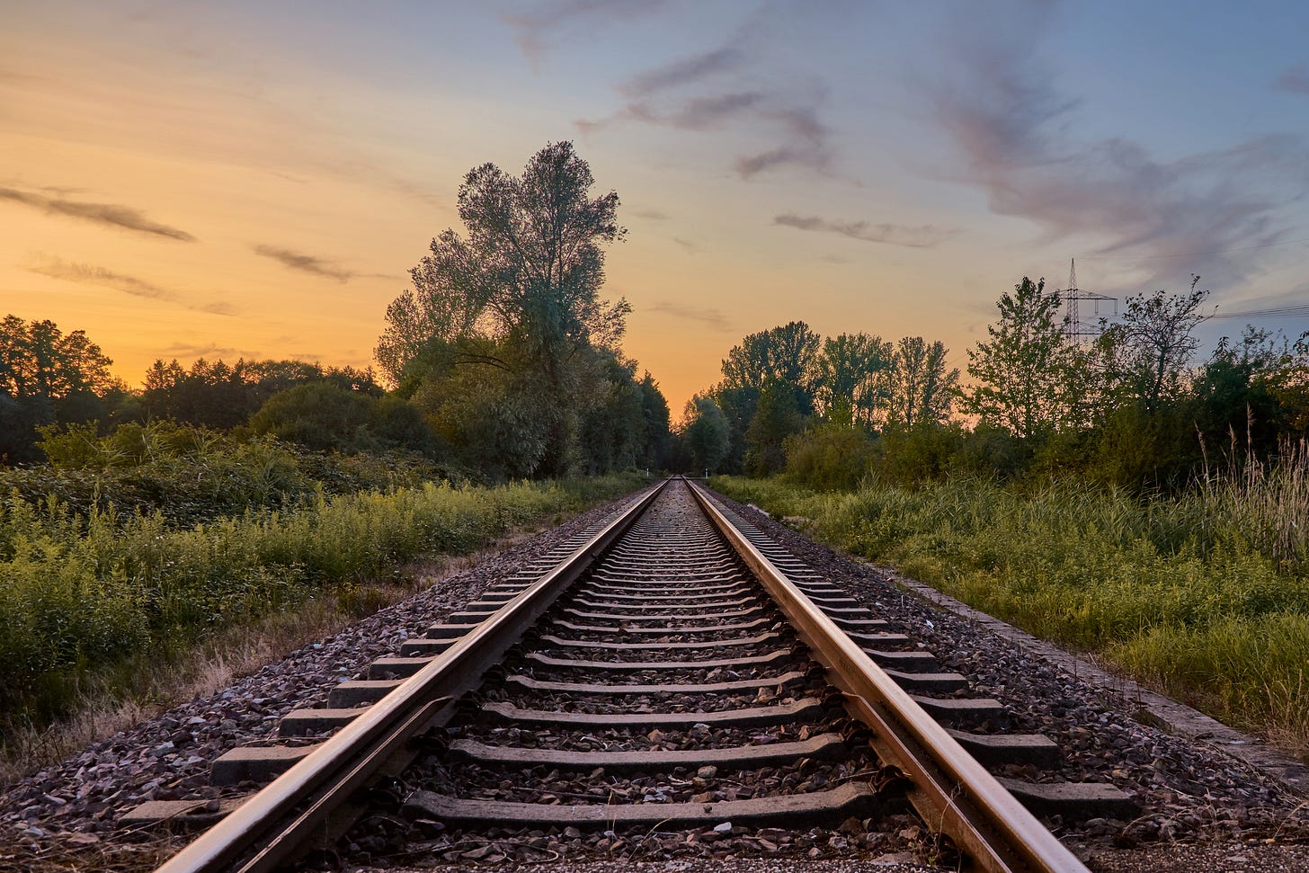 Parallel railroad tracks appear to converge in the distance.
