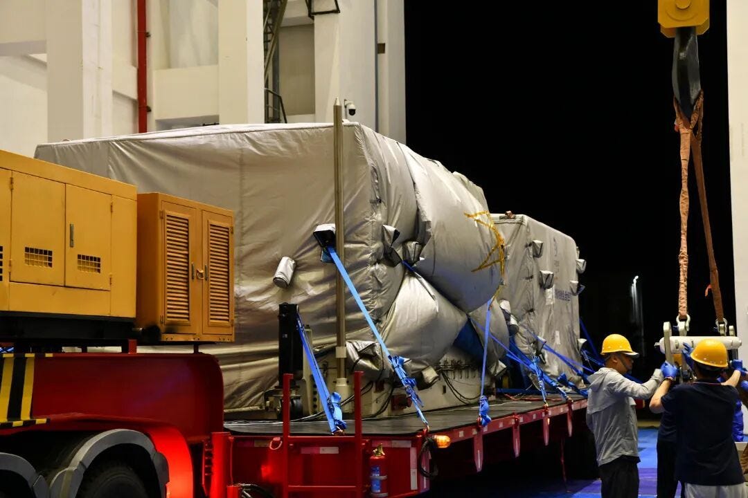 Two specialized containers of hardware for Chang’e 7 arriving in the delivery bay of one of the Wenchang Space Launch Sites’ cleanrooms.