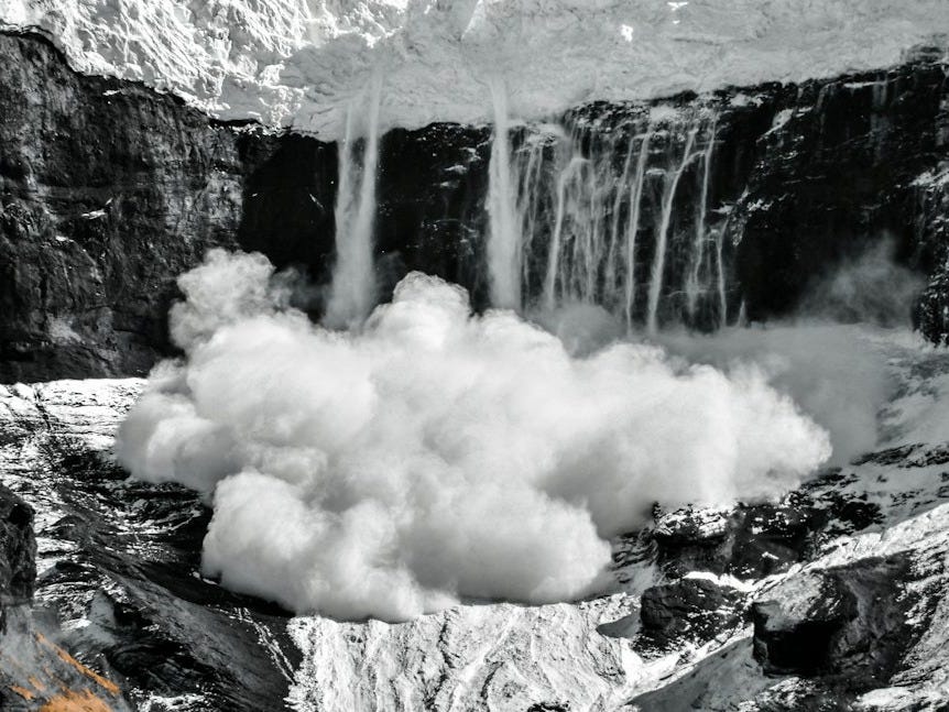 a mountain with a waterfall coming out of it a mountain with a waterfall coming out of it