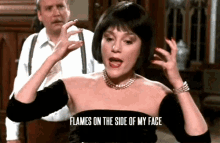 a woman says flames on the side of her face in front of a man a woman says flames on the side of her face in front of a man