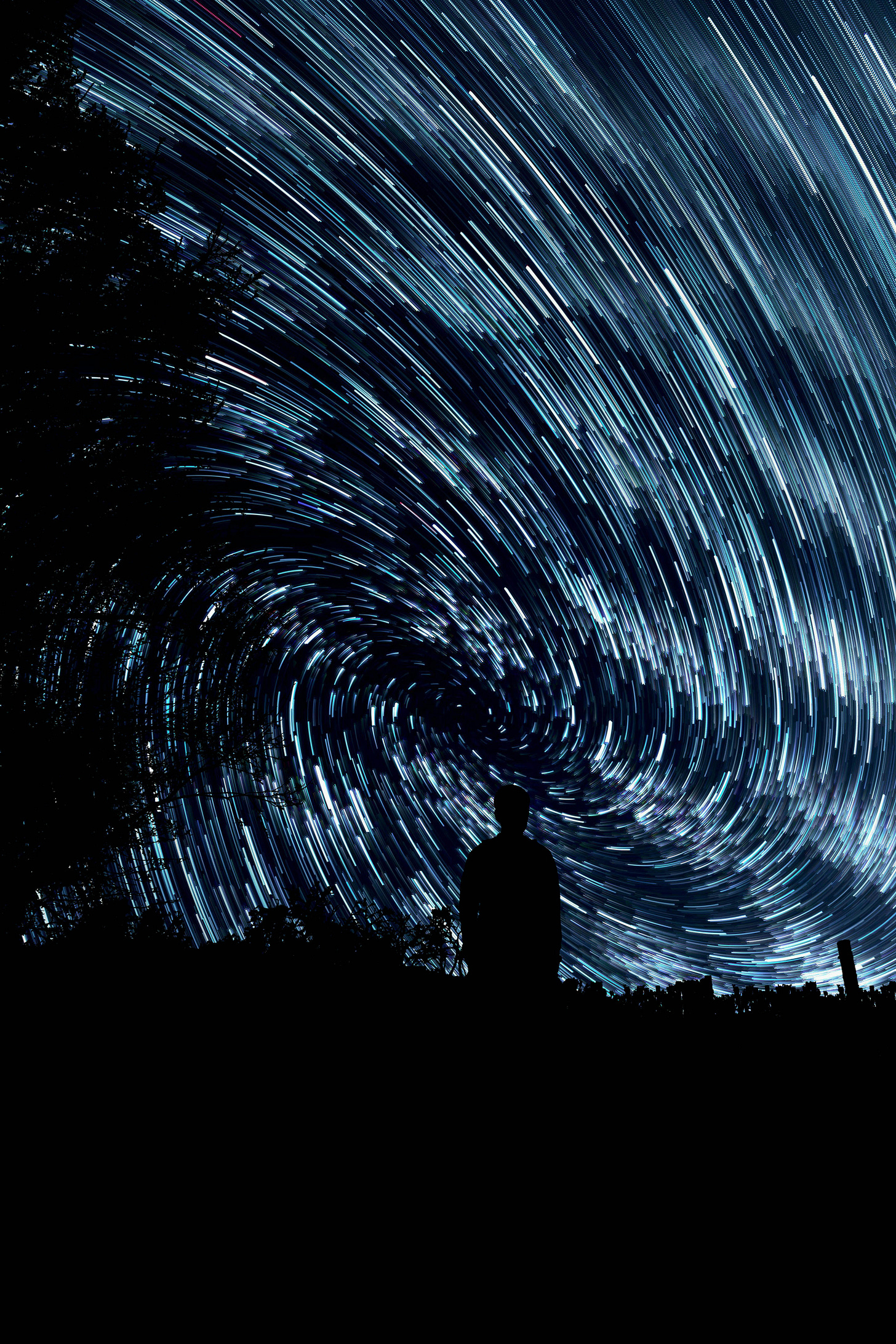 Long-exposure night sky with swirling star trails forming a vortex; silhouette of a person standing in the foreground among dark trees, looking up