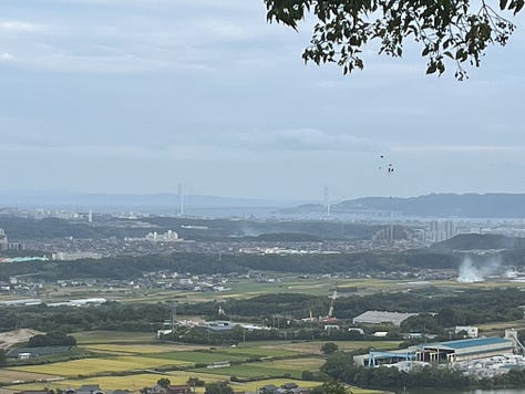 Distant view of Akashi Kaikyo Bridge and shrine toriis