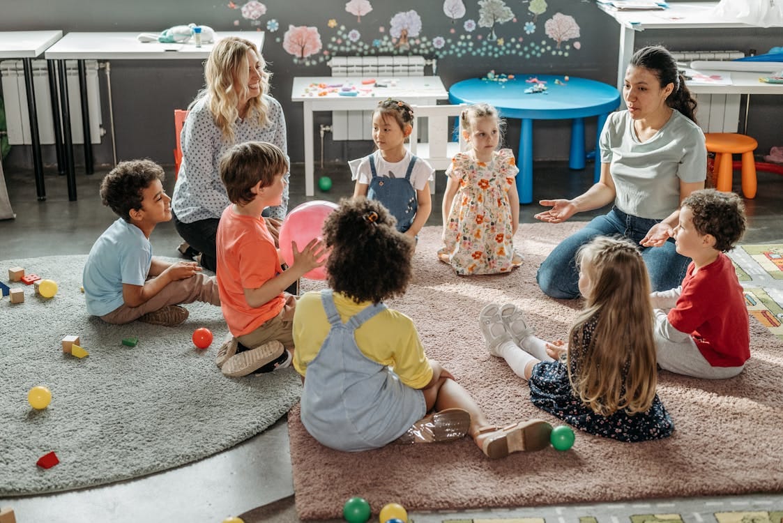 Kids with their Teacher Sitting on the Floor · Free Stock Photo Kids with their Teacher Sitting on the Floor · Free Stock Photo