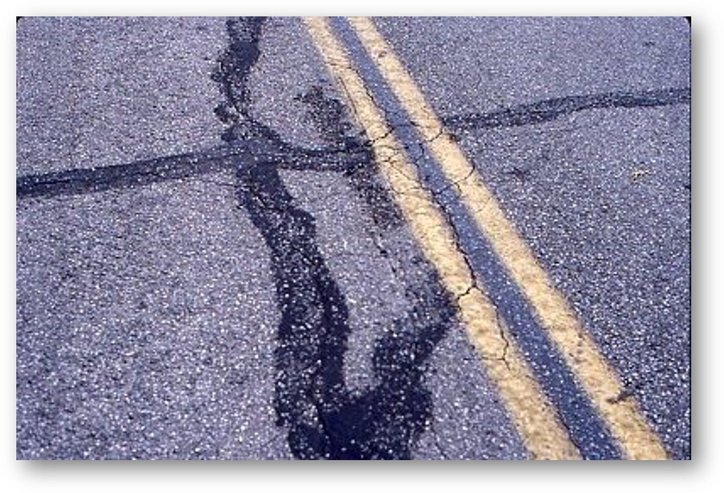 Shot of double yellow pointed line in roadway with indistinguishable physical evidence Shot of double yellow pointed line in roadway with indistinguishable physical evidence
