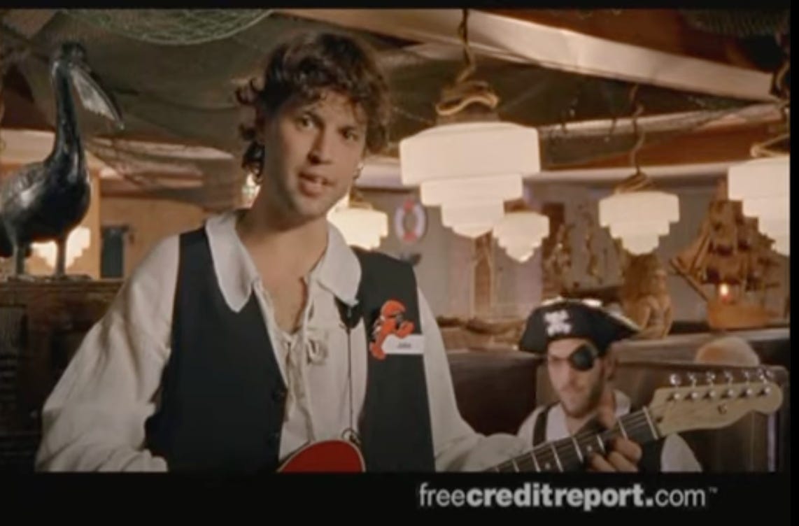 guy dressed up like a pirate holding a guitar in that free credit report dot com commercial