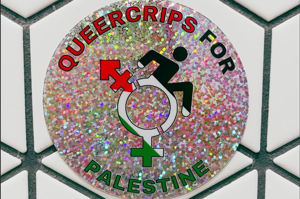 A silver glitter circle sticker that says “Queercrips for Palestine” with a Queercrip symbol in the center with the Palestinian flag in the symbol. The sticker is on a white cubes tile background with black grout. 