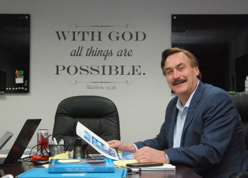 Mike Lindell reviews packaging design at his headquarters in Chaska. A Bible verse is printed on the wall.
