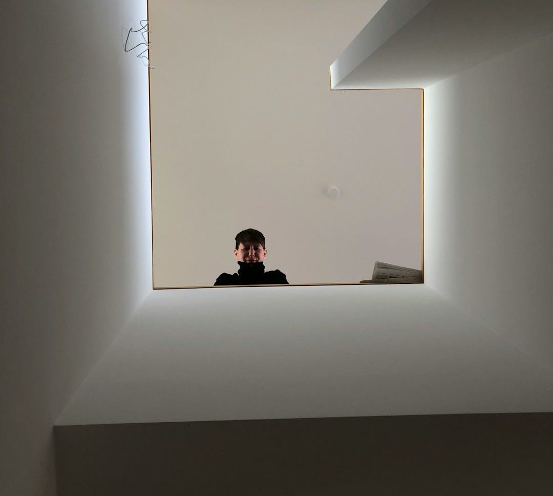 low-angle photography of man looking down from stair low-angle photography of man looking down from stair