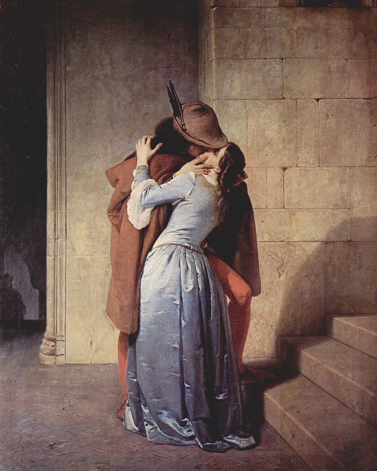 A couple embracing on a stone staircase A couple embracing on a stone staircase