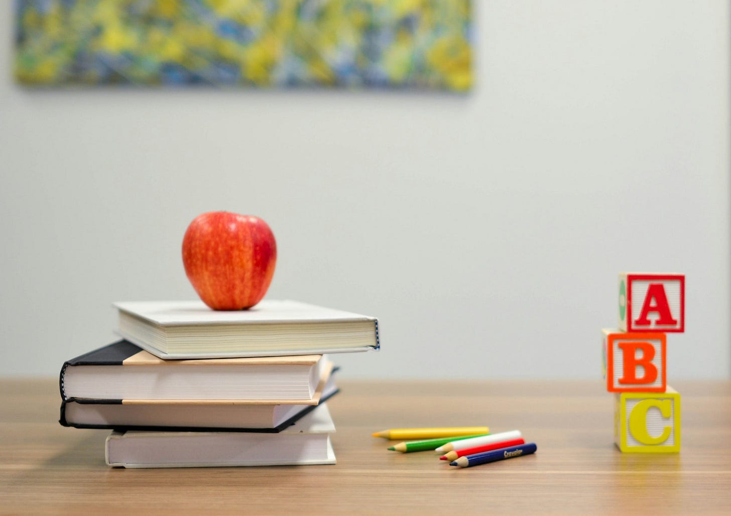 red apple fruit on four pyle books red apple fruit on four pyle books