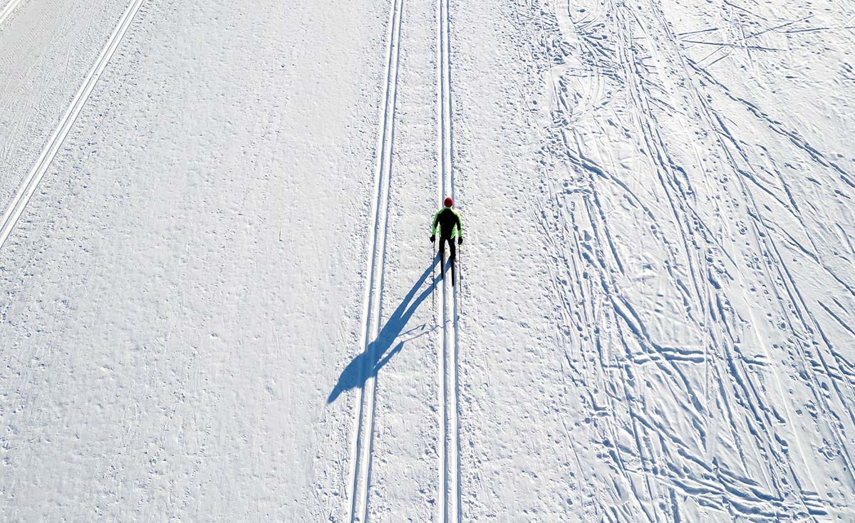 A cross country skiier on a track. 