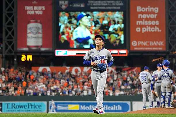 Yoshinobu Yamamoto of the Los Angeles Dodgers leaves the field after a home run by Jackson Holliday of the Baltimore Orioles in the ninth inning at...