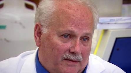 Dr. Ralph Baric, a University of North Carolina virologist, photographed in a laboratory wearing a white lab coat.