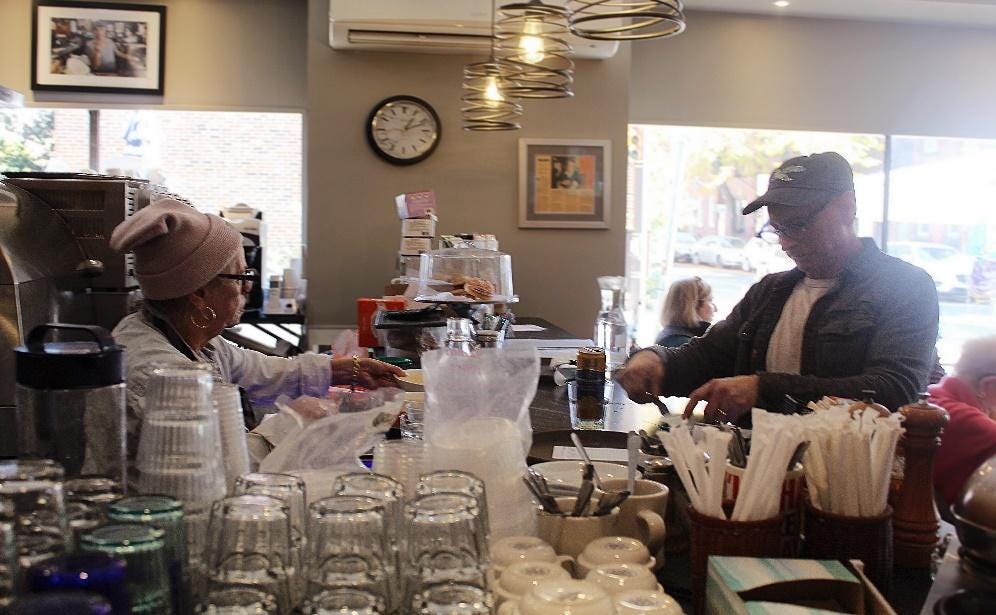 A couple of people in a cafe

Description automatically generated