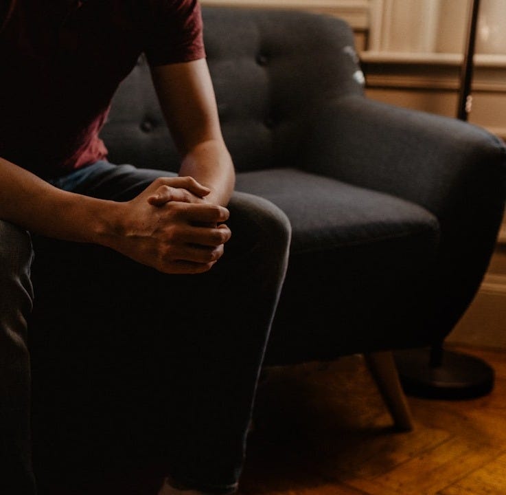 man sitting on sofa man sitting on sofa