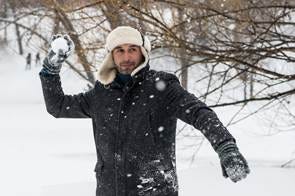 A person in a black coat and earmuffs holding a snowball

AI-generated content may be incorrect.
