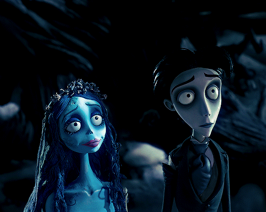 This may contain: corpse from the animated movie corpse is standing next to a woman with long hair and blue makeup