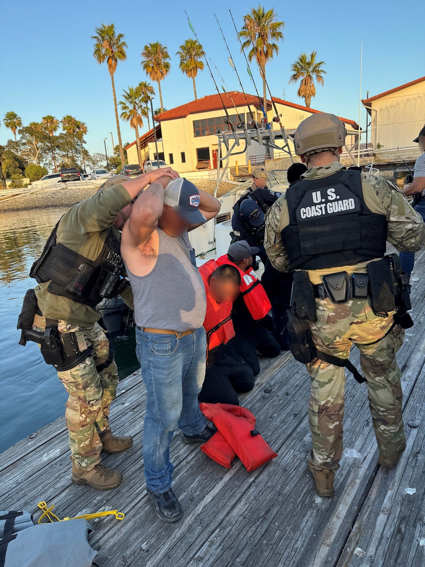 Once ashore, all aboard the intercepted human smuggling vessel were placed under arrest and transferred to the custody of the US Border Patrol. (US Coast Guard photo) Once ashore, all aboard the intercepted human smuggling vessel were placed under arrest and transferred to the custody of the US Border Patrol. (US Coast Guard photo)