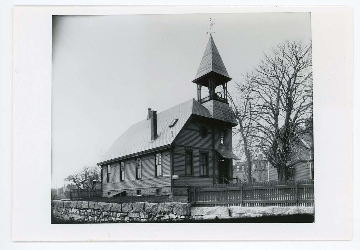 Black and white photograph of a small church on the waterfront
