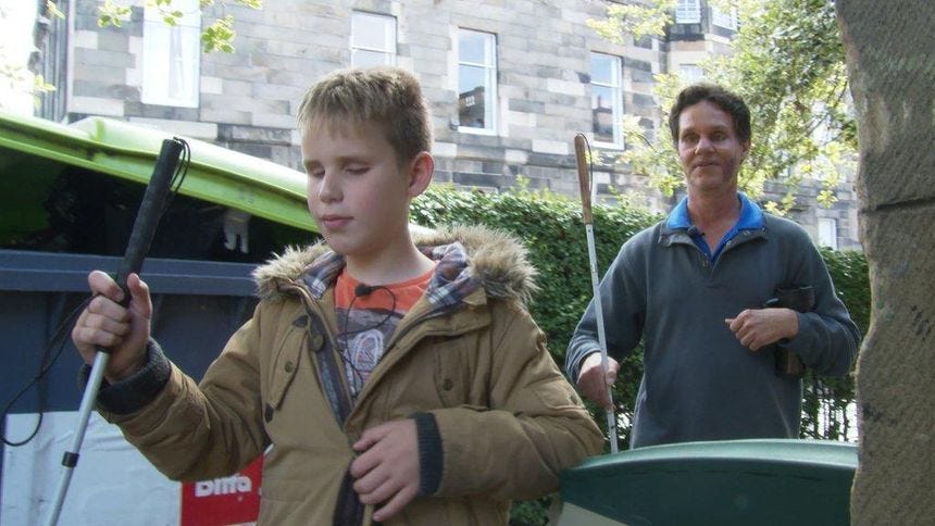 Ethan Loch and Daniel Kish at a school