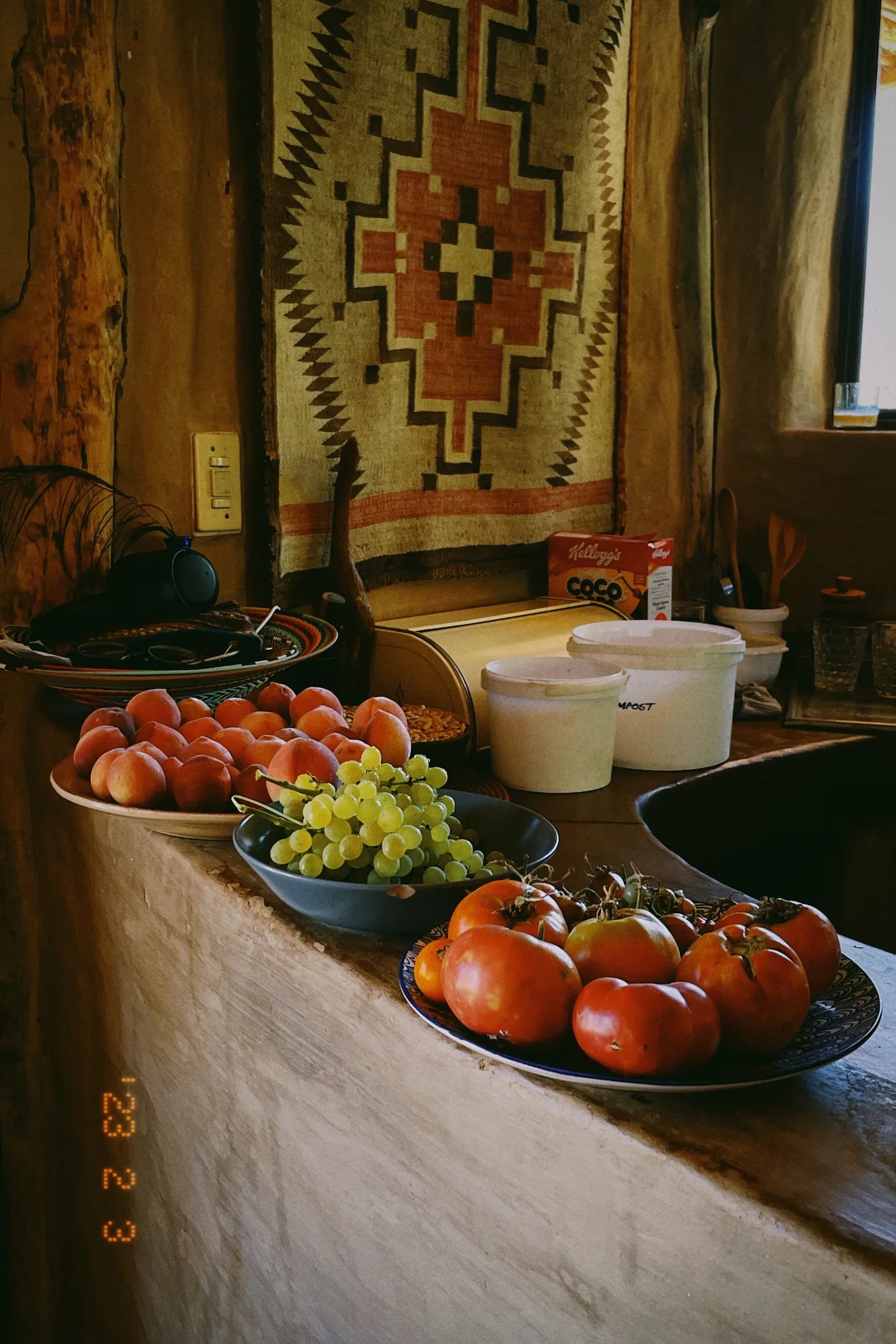 heirloom fruits lay in bowls on the counter of a kitchen at numbi valley