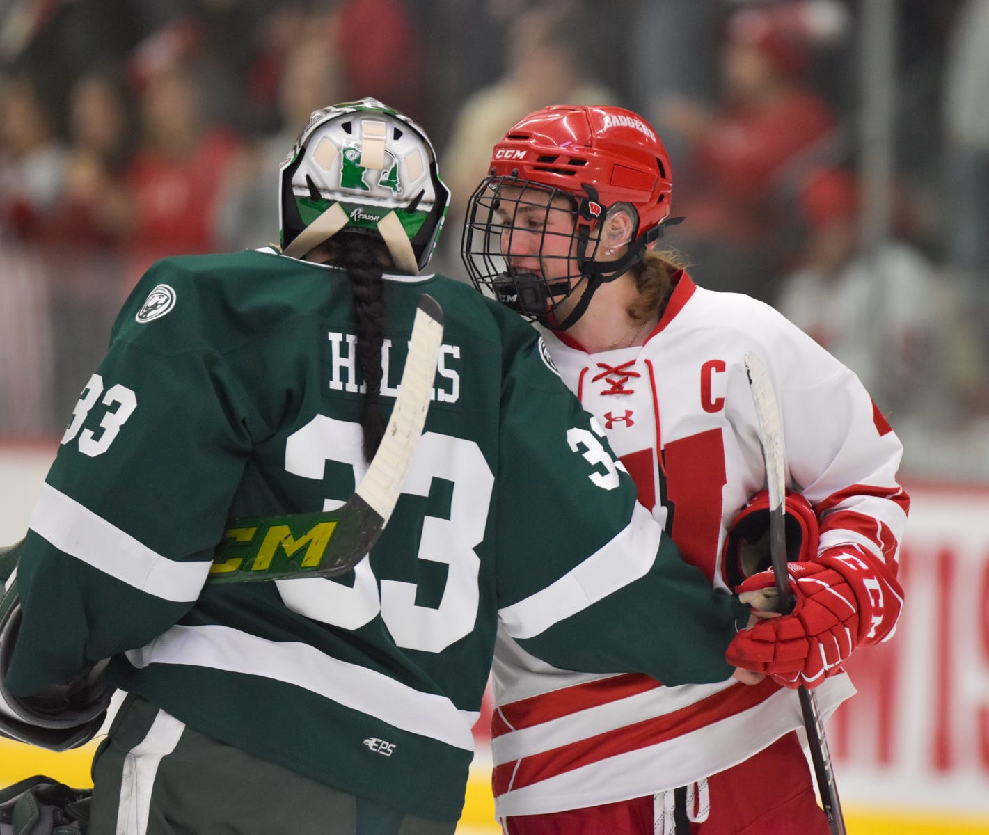 Harvey and Hills share a one-handed hug