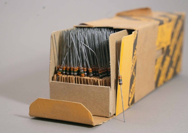 A box of vintage 1/2 watt resistors, with very long leads