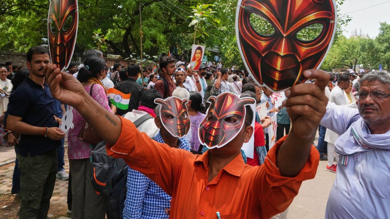 Supporters don cockroach masks as a mock political party for India’s young ‘cockroaches’ stages its first protest