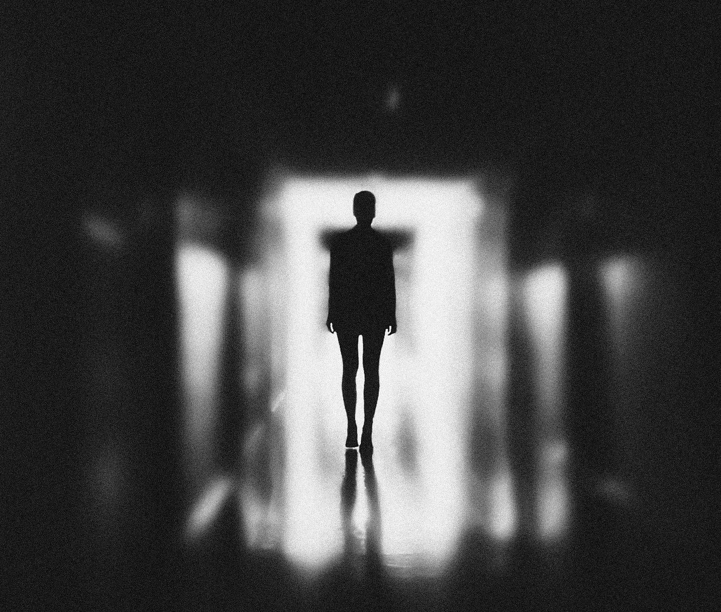 Liminal space: person standing in dark hallway