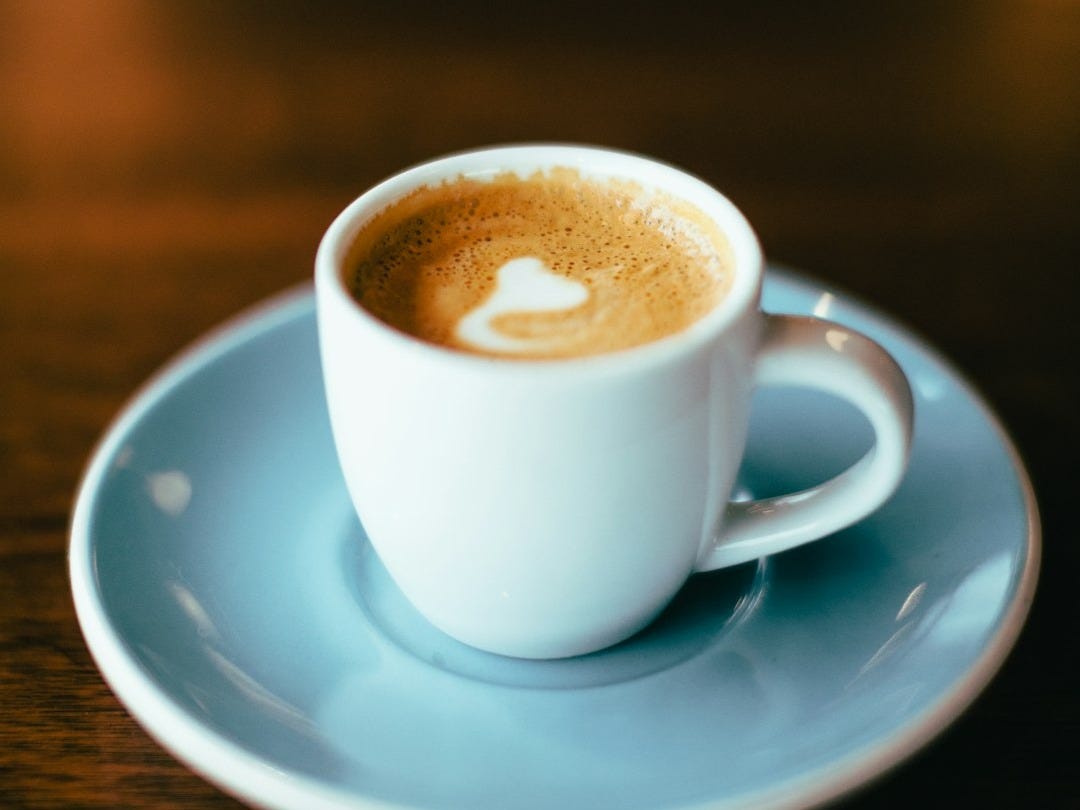 selective focus photography of latte in teacup
