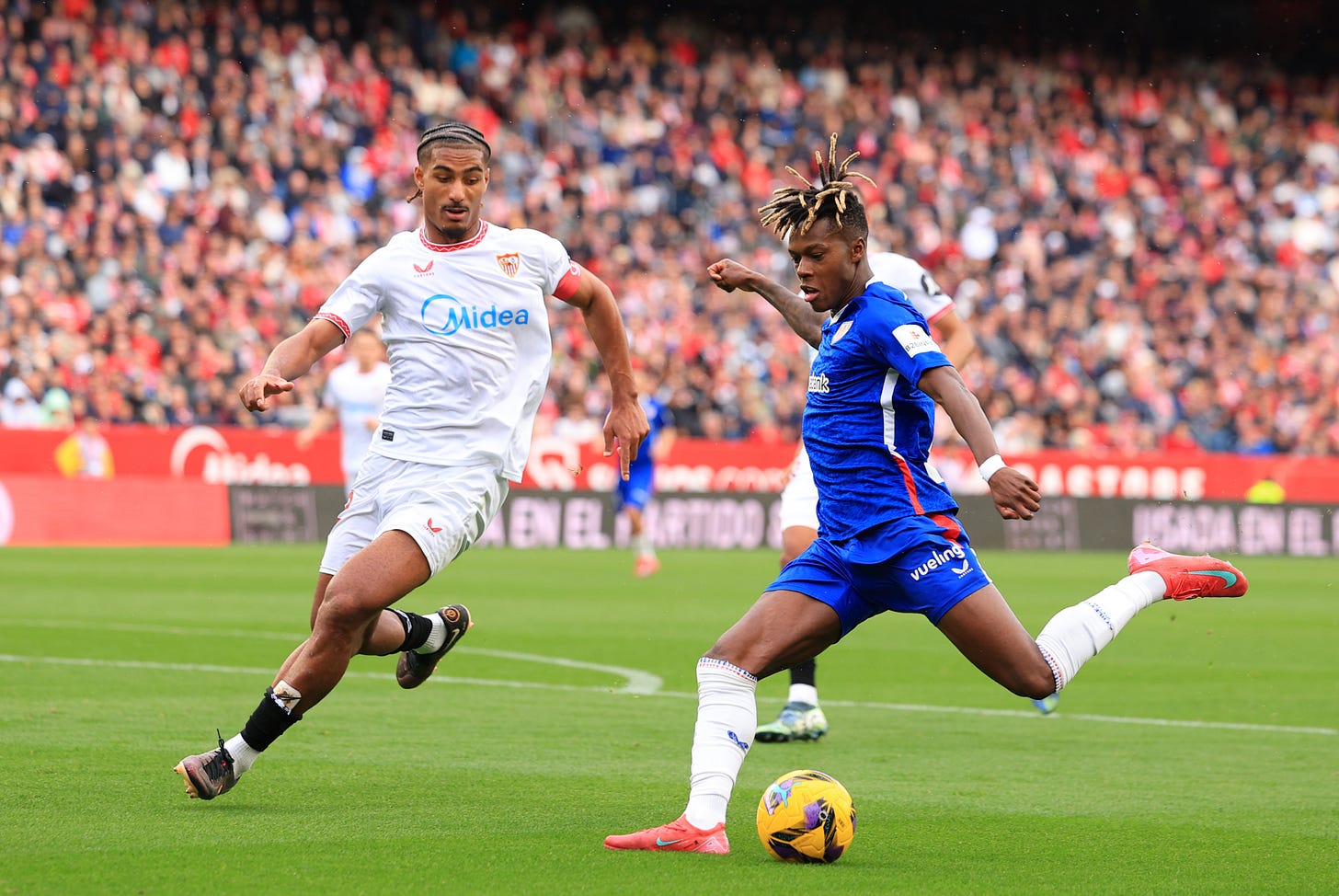 Loic Bade runs to try and tackle Nico Williams.