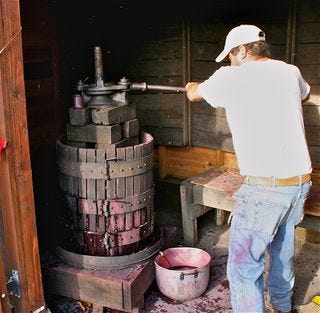 A - Tra Vigne- Hand-pressing the juice with wooden basket press at Charter Oak A - Tra Vigne- Hand-pressing the juice with wooden basket press at Charter Oak