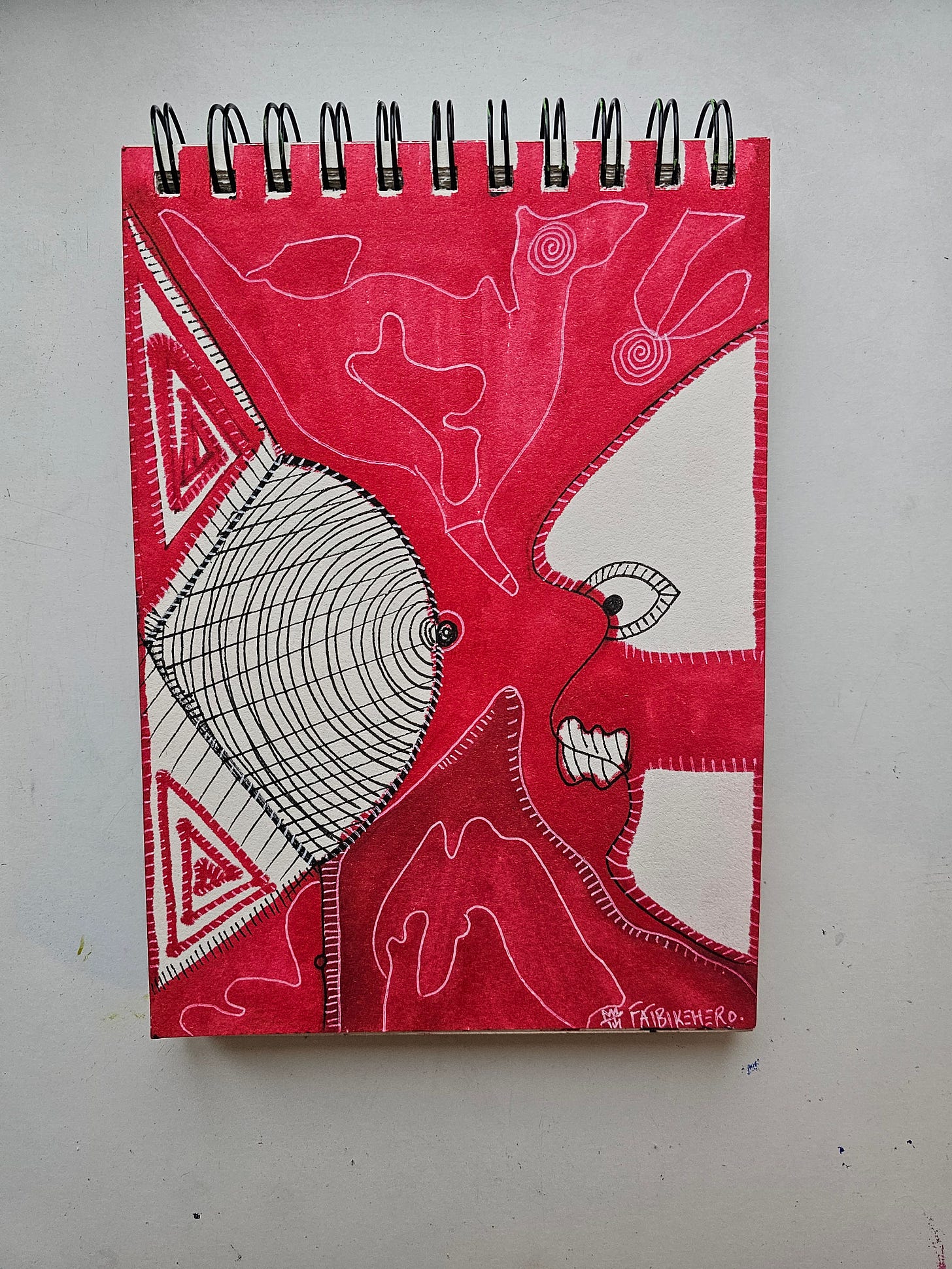 Front (Art): A vertical sketchbook drawing in red ink and black liner. On the right, a stylized profile face with wide eyes and gritted teeth faces left. On the left, a large, teardrop-shaped object resembling a breast is rendered in a black wireframe mesh pattern, suggesting a digital 3D model. The background is a washed red with geometric triangle patterns and organic white lines.